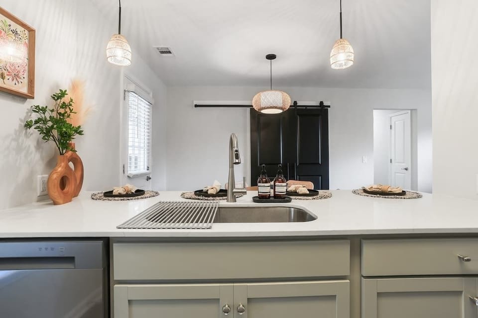 Small but functional kitchen overlooking the dining area, perfect for staying connected while preparing meals.