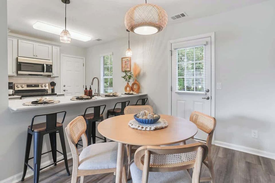 Cozy dining nook sits just beside the breakfast bar, making it easy to gather for meals or casual snacks.