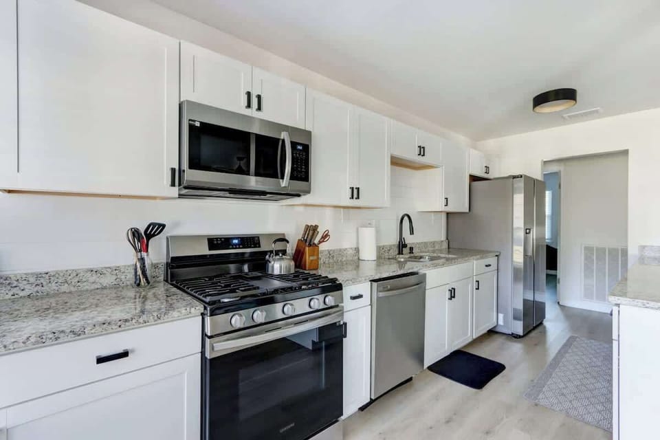 Ample natural lighting floods this long kitchen, highlighting its light, minimalist design. 