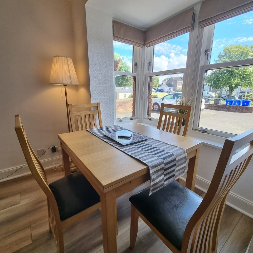 Dining table with 4 chairs within living room