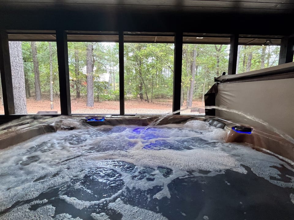 Relax and unwind in the private hot tub, surrounded by nature and bubbling serenity.