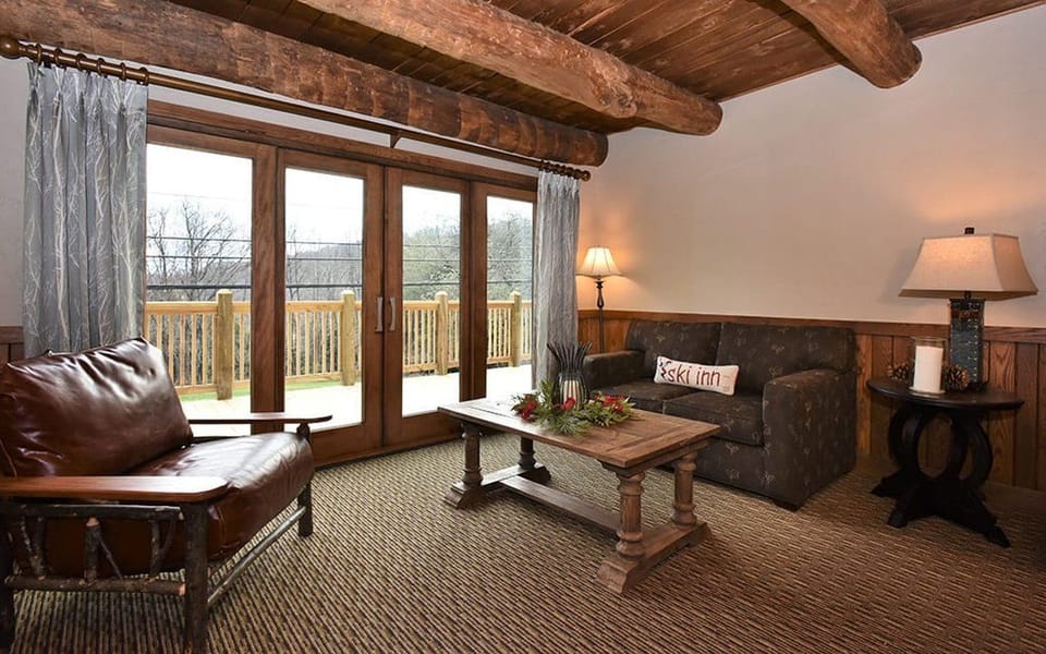 Inviting living area with large windows and rustic decor, perfect for enjoying the views and cozy evenings indoors.