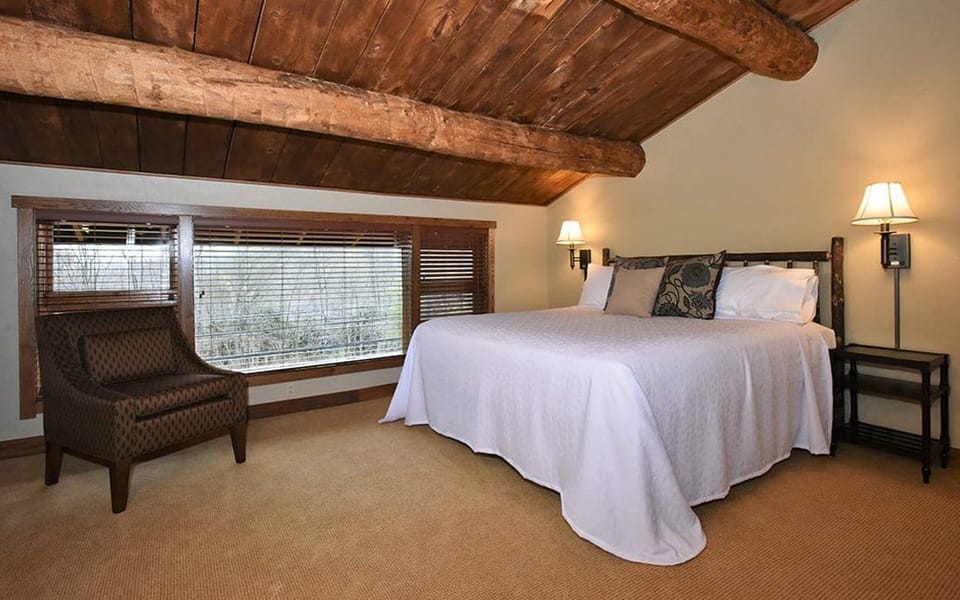 Tranquil bedroom with a cozy atmosphere and wooden accents, offering a peaceful space to relax.