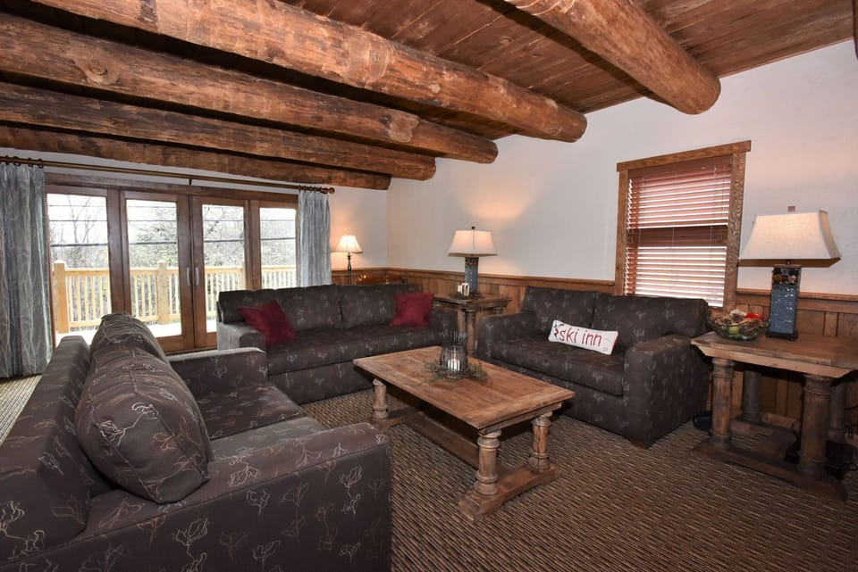 Welcoming living space featuring exposed beams and plush seating, perfect for unwinding after a day of adventure.
