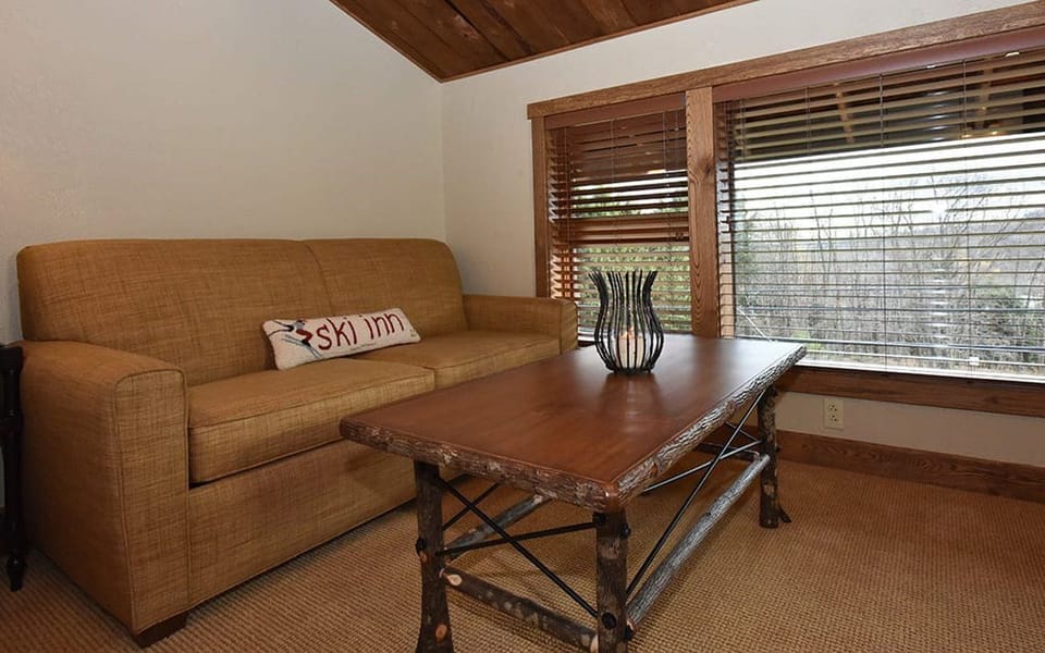 Comfortable seating area with large windows, ideal for a quiet moment with a book or enjoying the natural light.