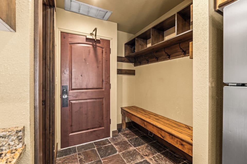 The entryway with a large bench and plenty of space to put outdoor gear.