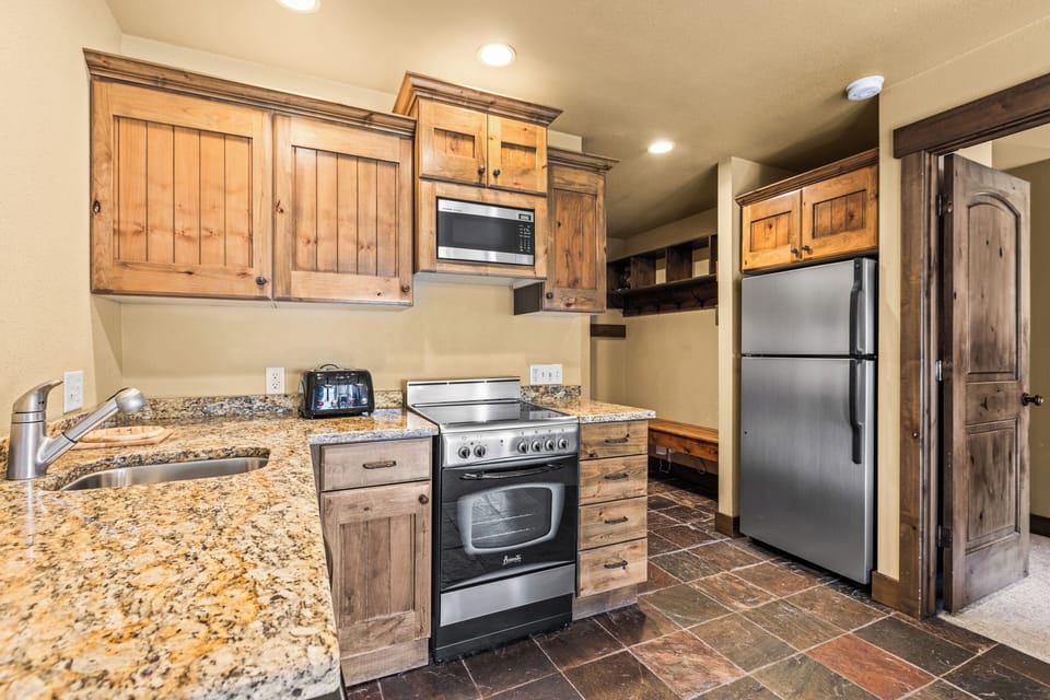 The efficient kitchen with oven, refrigerator, microwave, and dishwasher.