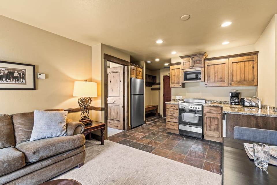 Unwind in your open-concept retreat where rustic wood cabinets and granite counters create a cozy mountain feel.