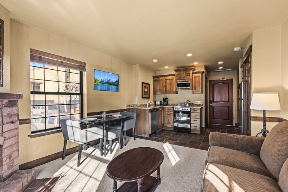 The open concept living area with efficient kitchen and dining table for two guests.
