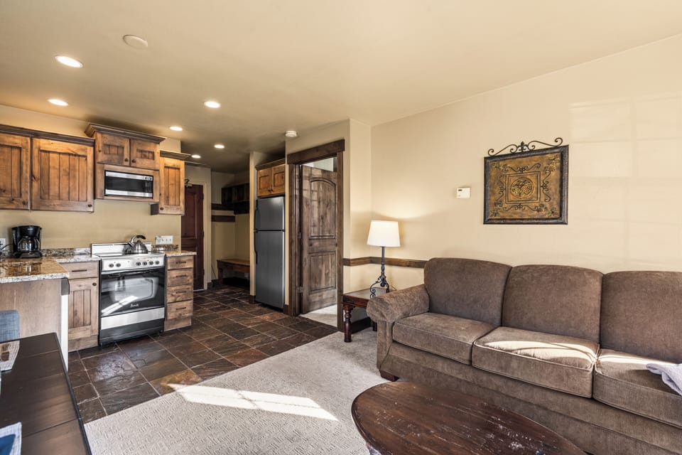 The open concept living area with efficient kitchen and dining table for two guests.