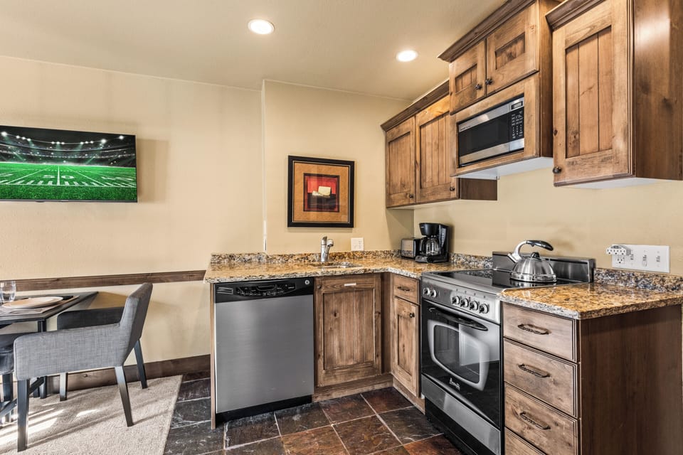 The efficient kitchen with oven, refrigerator, microwave, and dishwasher.
