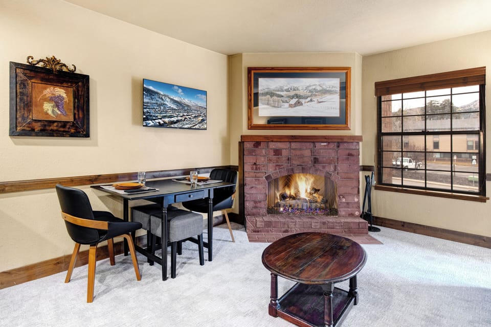 Cozy up in this charming living space where a crackling fireplace creates the perfect ambiance for your mountain getaway.