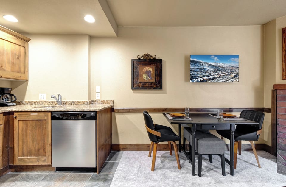 Your modern mountain retreat features a fully equipped kitchen with granite counters and stainless steel appliances.