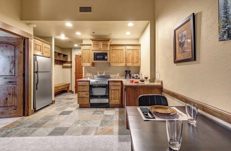 Step into your mountain-inspired kitchen where rustic wood cabinets meet modern convenience.