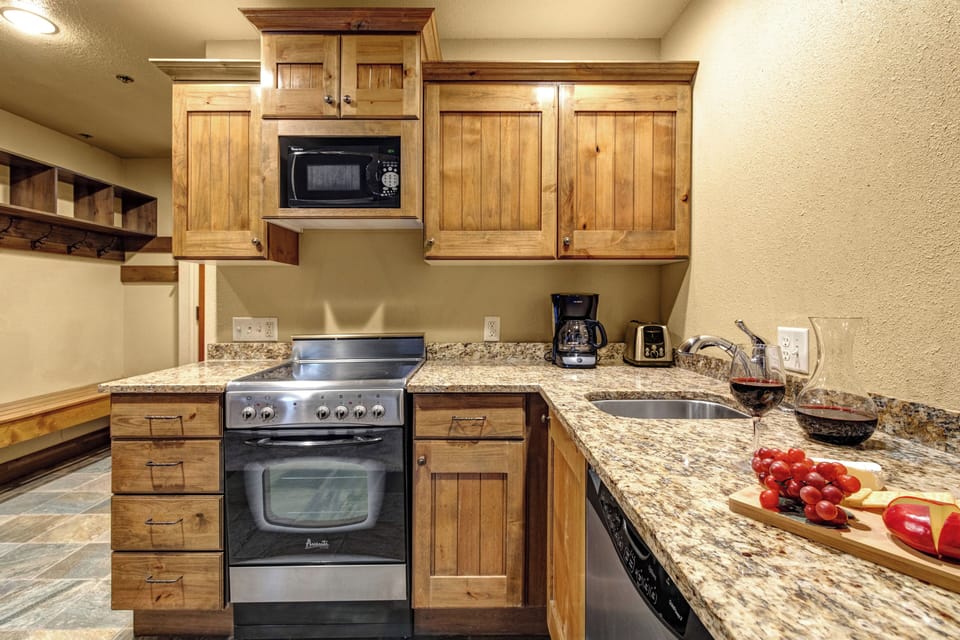 Your fully equipped kitchen awaits with warm wood cabinets and granite countertops.