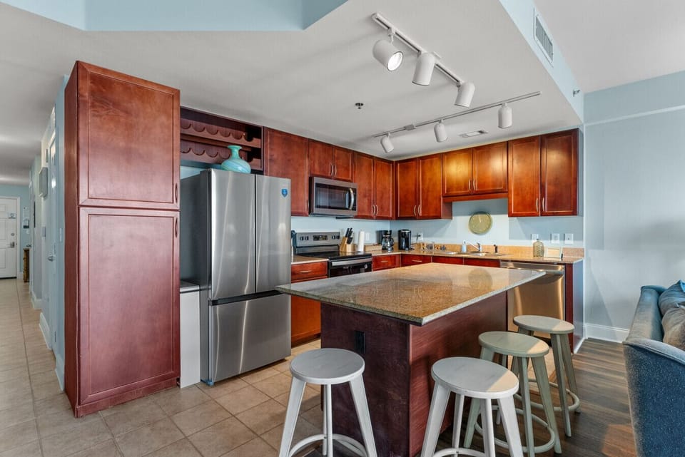 Kitchen: Fully equipped kitchen with modern stainless-steel appliances, granite countertops, and plenty of cabinet space for all your vacation cooking needs.