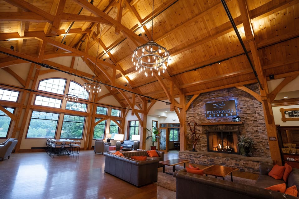 Warm wood tones and soaring ceilings create a welcoming space that blends rustic charm with refined comfort.