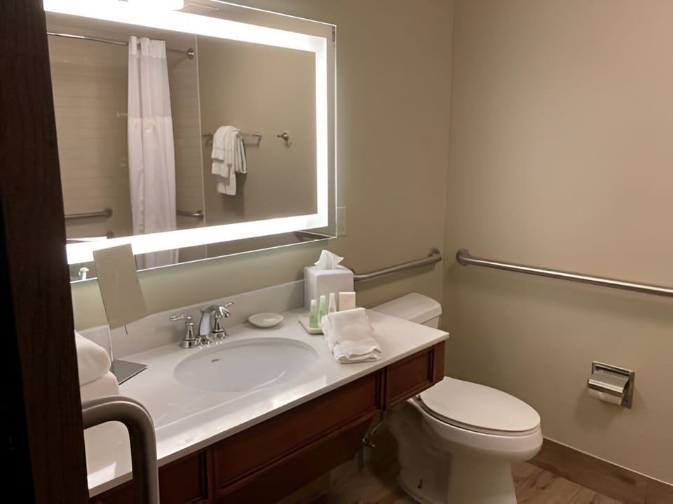 Spacious vanity and soft lighting create a peaceful and accessible space to refresh and prepare for the day.