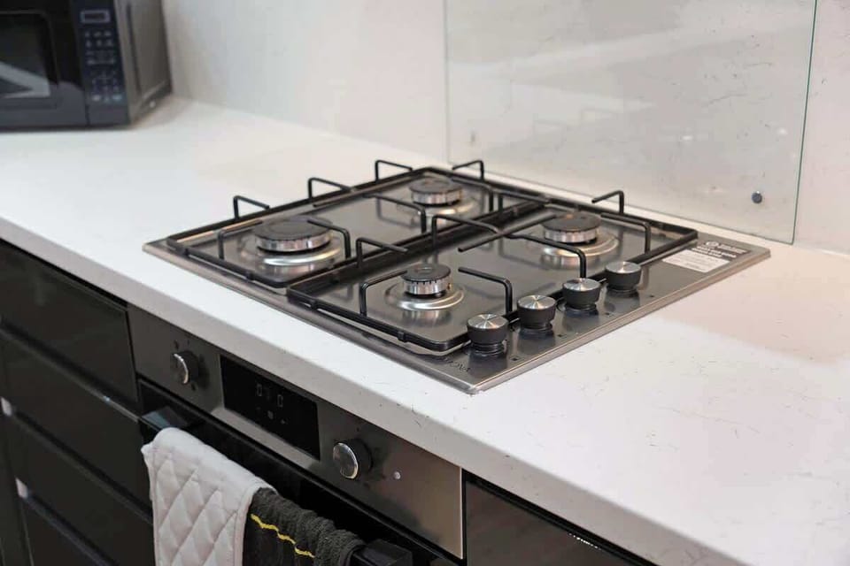 Kitchen equipped with all essentials, including a oven, fridge and full cookware set.