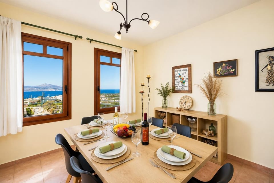 Living room with sofa, dining area, ornamental fireplace, A/C, WiFi internet, and satellite TV