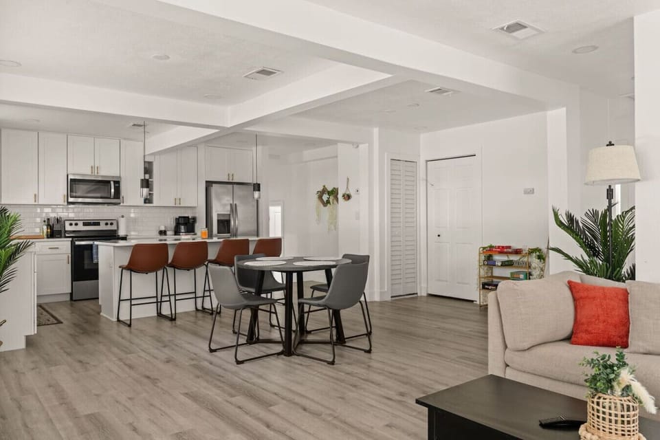 Dining table conveniently located next to kitchen and living space
