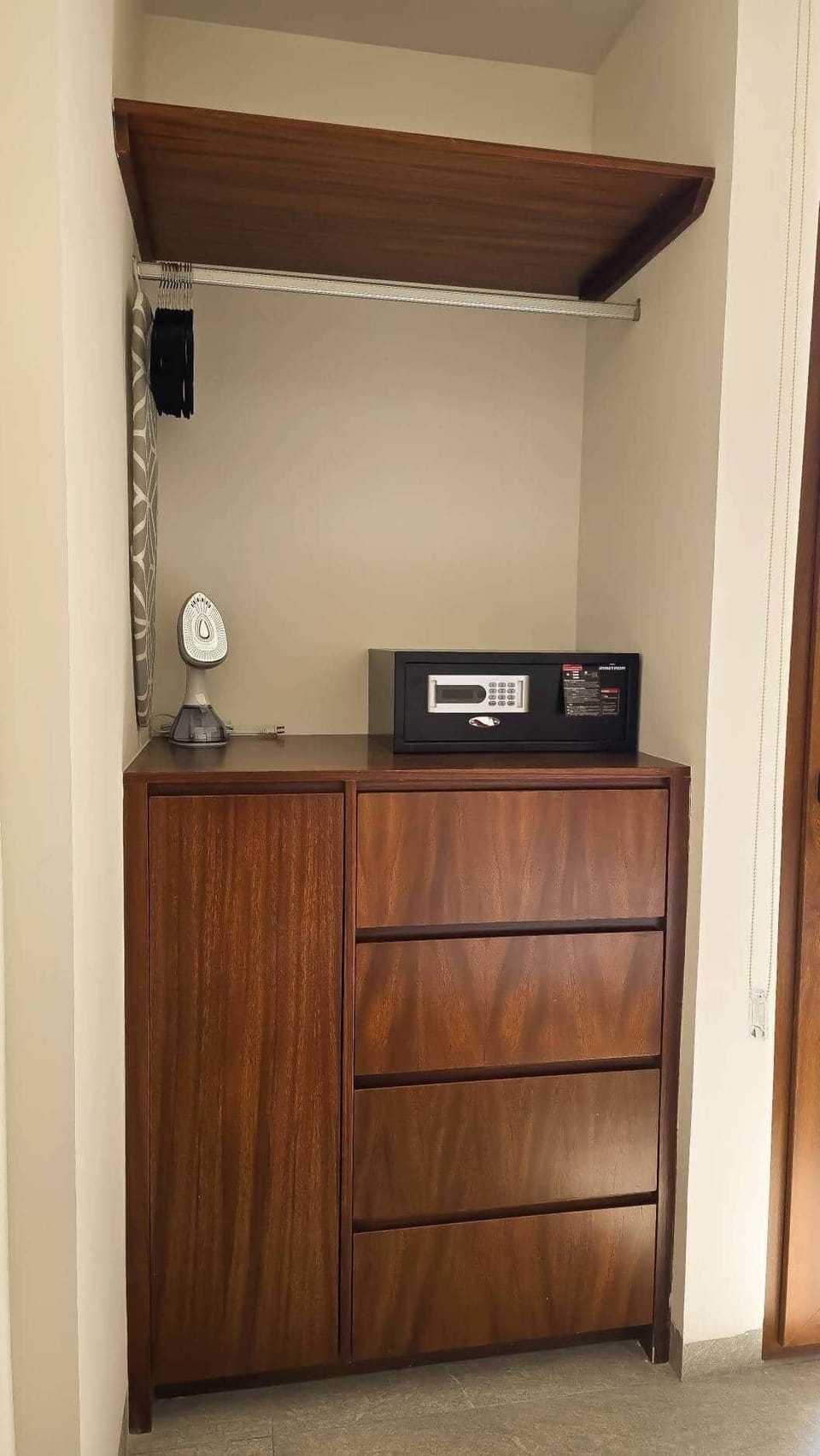 Spacious closet with custom parota cabinetry, secure digital safe, and in-room steamer/iron.