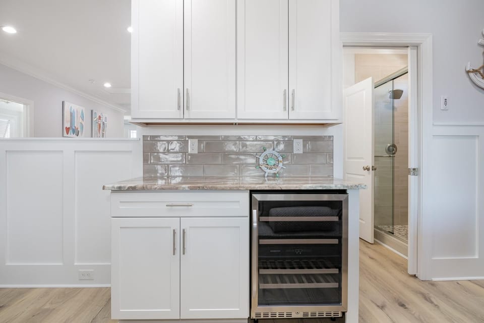 Chic kitchenette with sleek wine cooler and ample storage