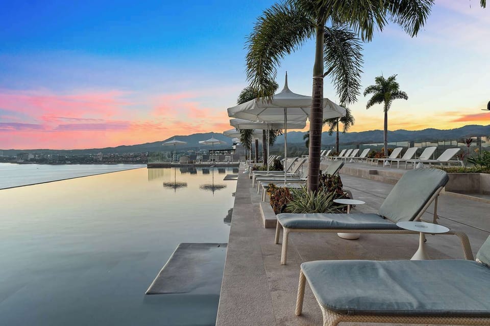 Rooftop infinity pool at sunset 