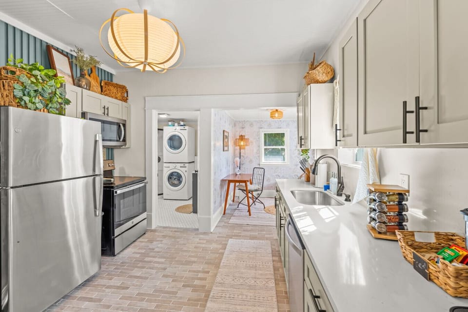 Fully equipped kitchen w/ clean lines, ample counter space, & everything needed for easy meals or coffee runs.