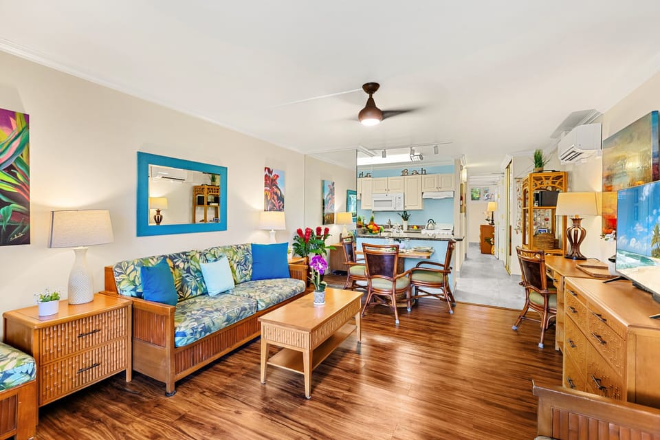 Bright and airy living room with a queen sleeper sofa, brand-new flooring, and a mini-split AC to keep you cool between island adventures.