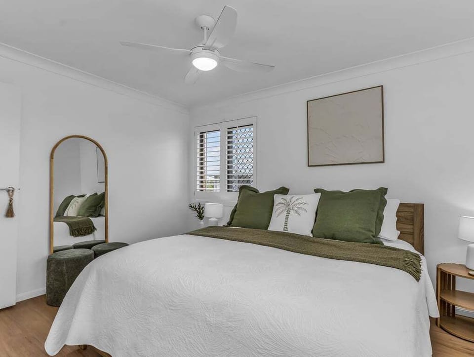 Spacious bedroom with natural light and serene ambience.
