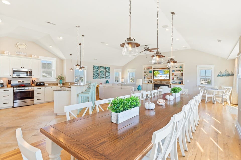 Large dining table with seating for sixteen plus an additional table for four—ideal for group meals and celebrations.