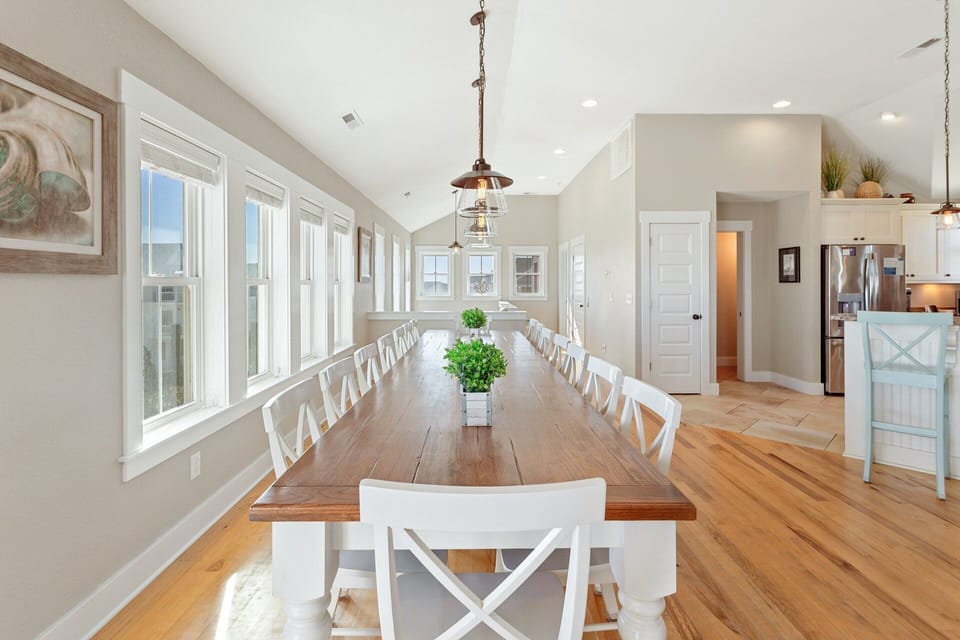 Large dining table with seating for sixteen plus an additional table for four—ideal for group meals and celebrations.