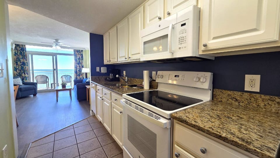 Bright galley kitchen overlooking living area