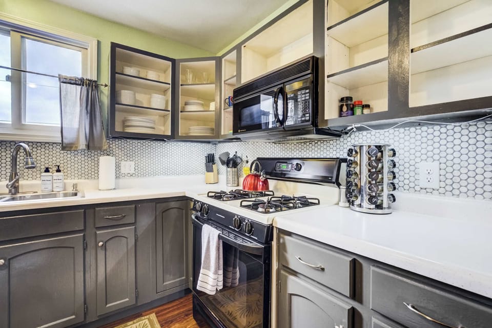 Equipped with a gas range, modern cabinetry, and full cookware, this kitchen is ready for your favorite meals. The updated design blends convenience with contemporary charm.