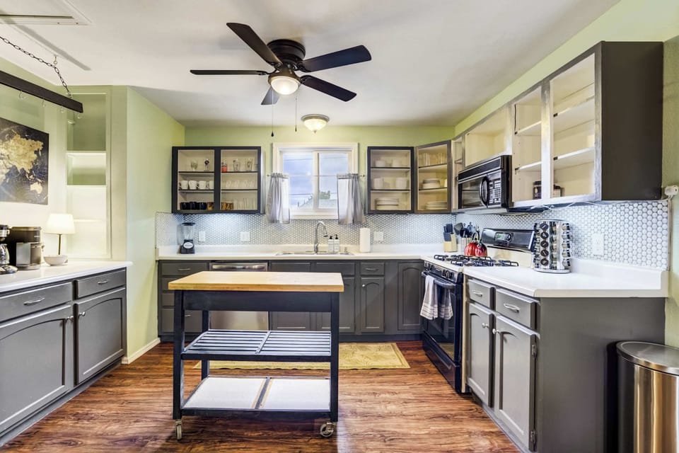 A fully stocked kitchen with stainless appliances, a gas range, and plenty of counter space makes cooking a pleasure. The island offers extra prep space or a convenient breakfast spot.