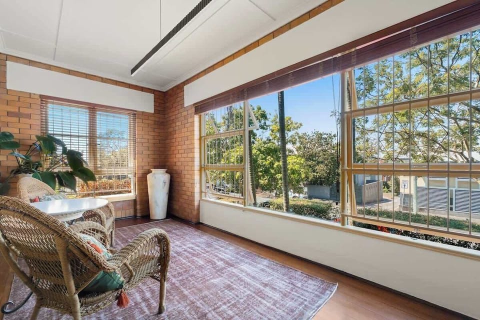 Sunroom overlooking streetscape with home office