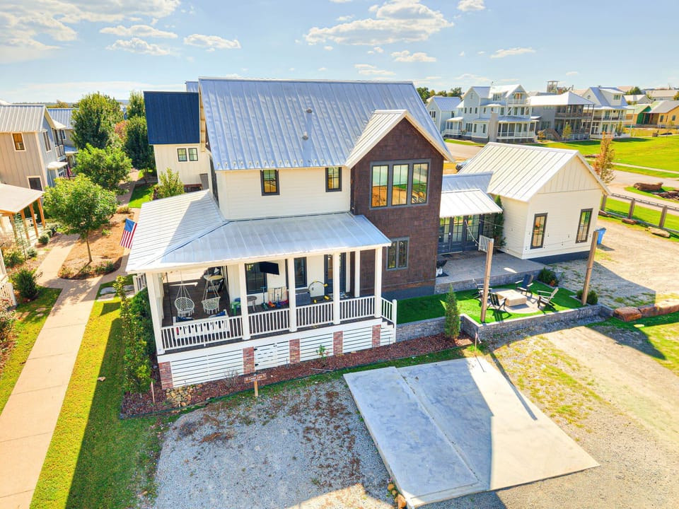 11. Classic black-and-white façade with front porch swings and lush greenery — a warm first impression at Hideaway 56.