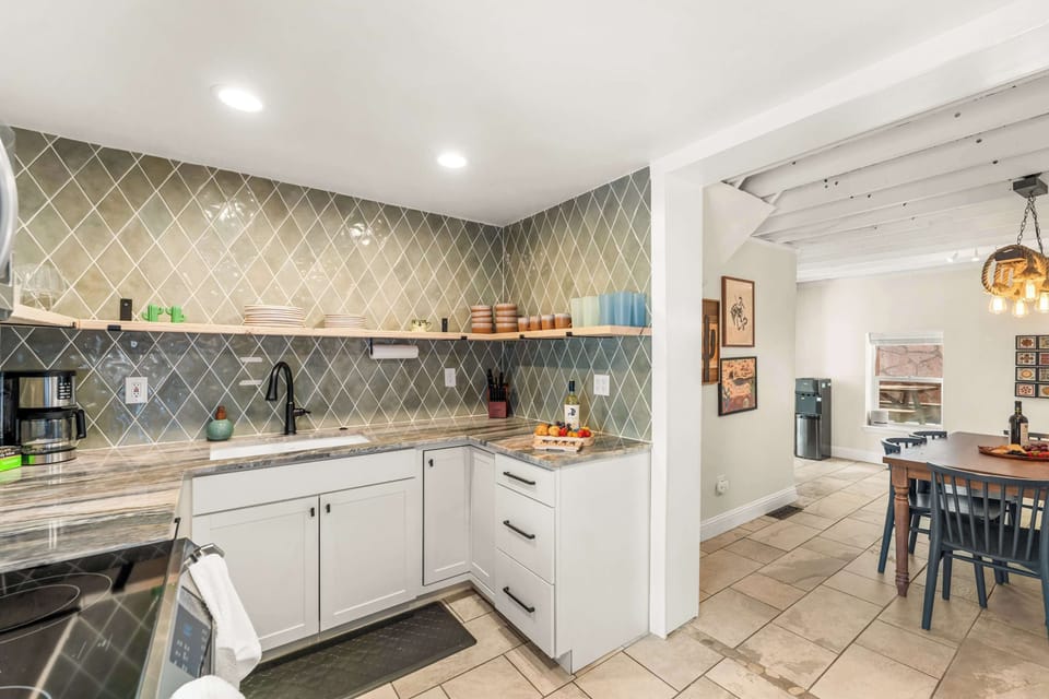 Fully stocked kitchen, with drip coffee maker (complimentary ground coffee, sugar and tea), cookware, dinnerware, and spices. Guests supply their own condiments.