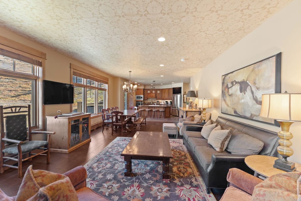 Unwind in your spacious living room where warm wood accents and cozy seating create the perfect gathering space for memorable evenings.
