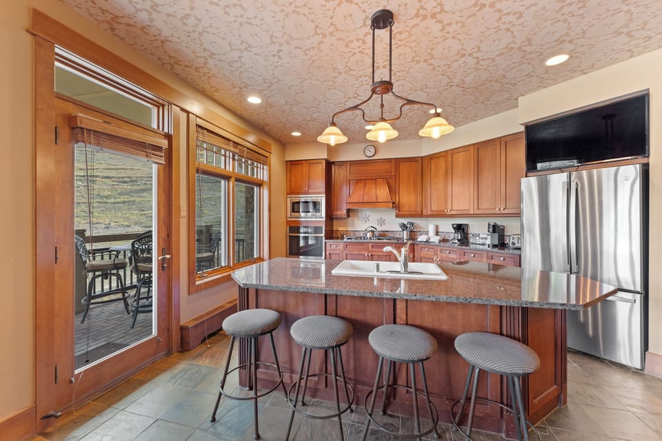 Your spacious kitchen features granite counters, stainless appliances, and a breakfast bar where you can sip morning coffee while gazing outdoors.