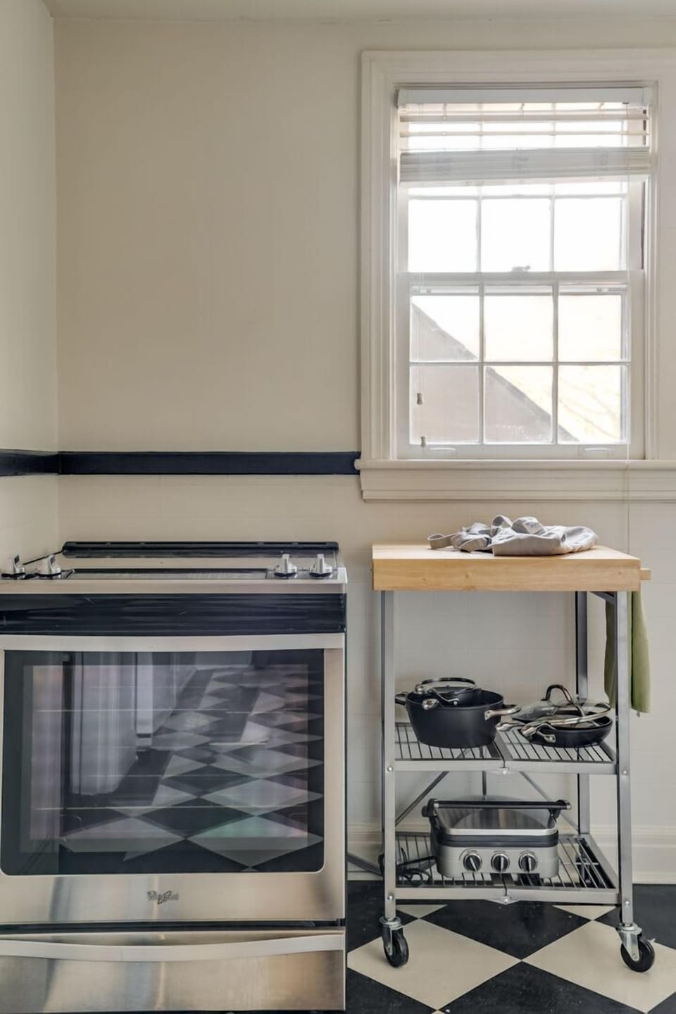 Full kitchen featuring crisp white cabinetry and sleek granite countertops