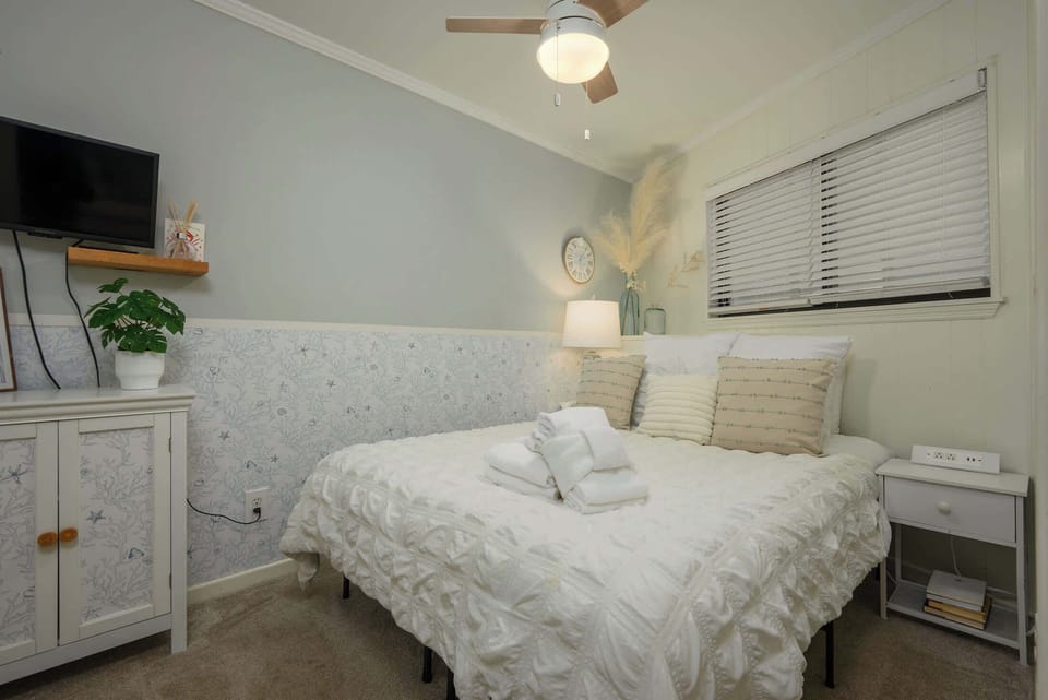 Serene primary bedroom with queen bed, Smart TV, and comfort.