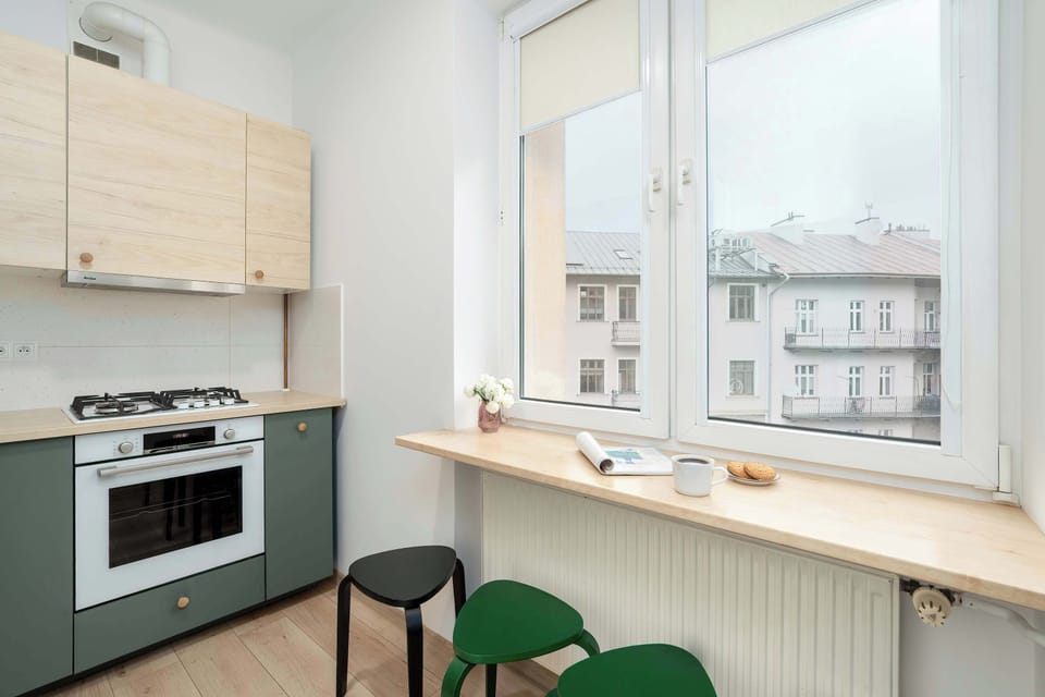 The kitchen's sleek design includes all necessary cookware and utensils.