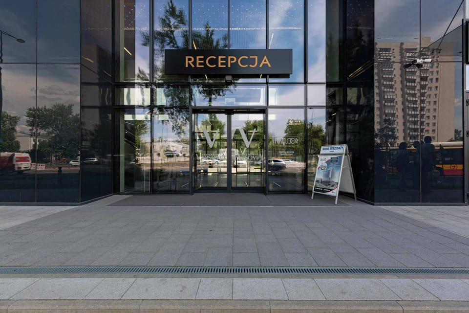 The reception area with glass doors and modern design reflects the high standard of service throughout the property.