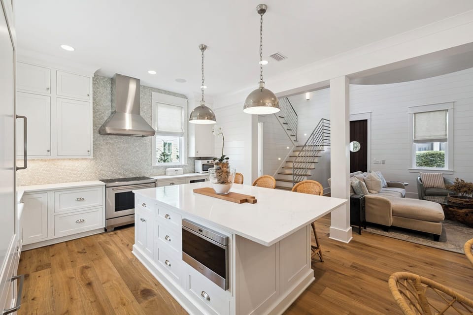 Your spacious kitchen features gleaming white counters and a large island where you can prepare meals while chatting with loved ones.