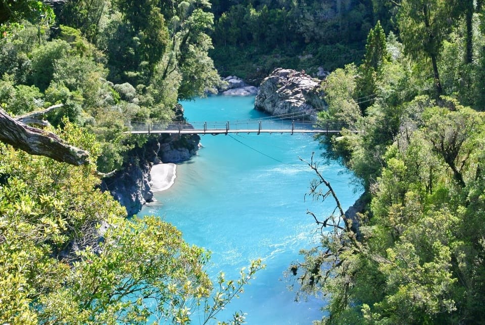 Discover a pocket of paradise at Hokitika Gorge, where crystal clear waters and ancient rocks tell their story - just 30 minutes away from Beach Break.