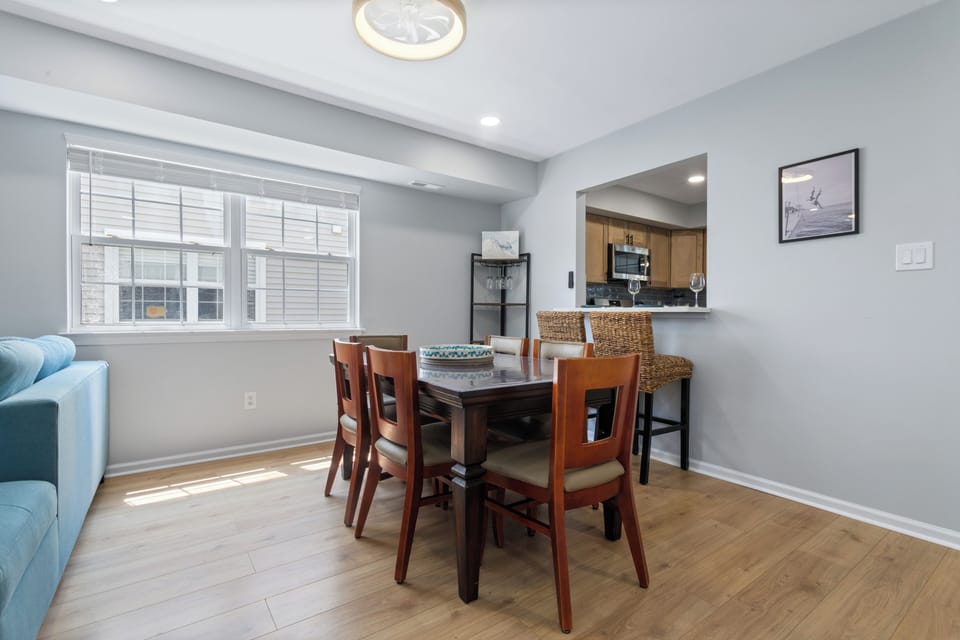 Dining area with 6 chairs. 6 more chairs and card table in closet.