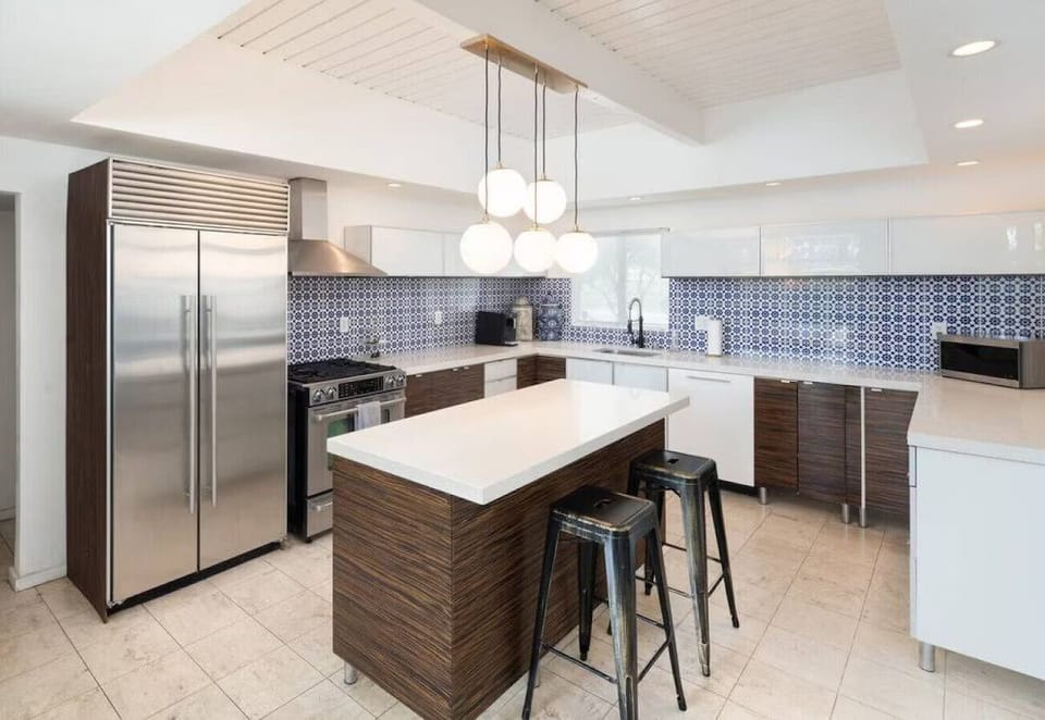 The perfect spot to connect. This kitchen features stylish bar seating for three, making it the ideal hub for morning coffee or evening appetizers.