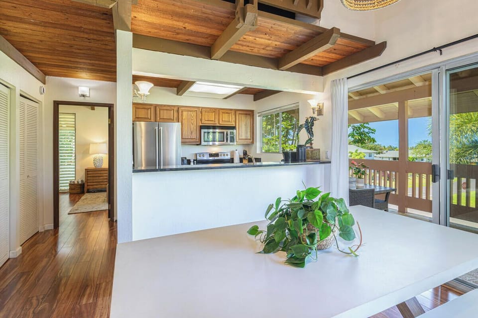 Airy layout showing the open concept. Connects kitchen, dining, and living spaces.